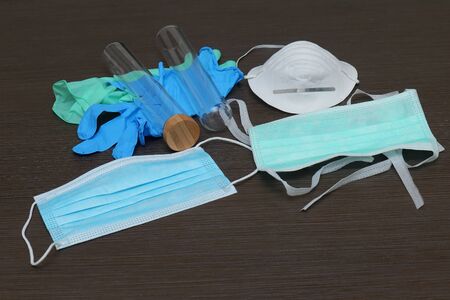 Medical equipment of face masks, gloves and test tubes used in laboratoryの写真素材