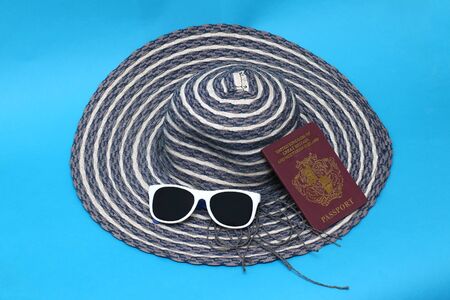 Passport with sun glasses and hat prepared for summer vacation travelの写真素材