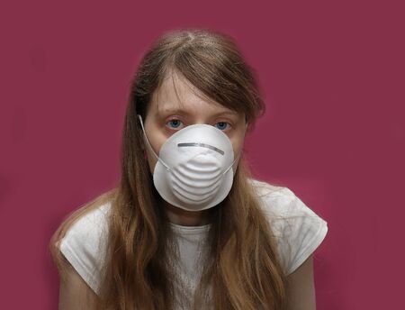Young woman with medical face mask protection from corona virusの写真素材