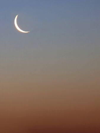 Contour of moon in sky during evening light background