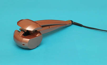 Electric hair curler accessory with cable for beauty treatmentの写真素材