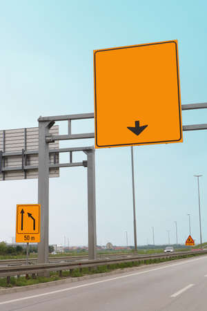 Empty highway road with traffic signs on all sides