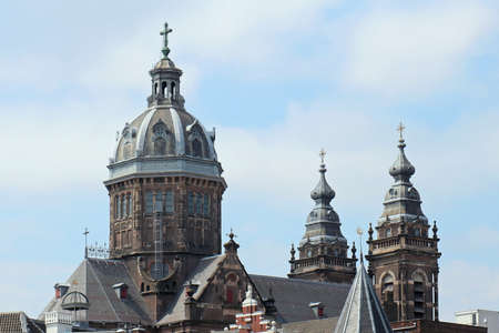 Old domes of Catholic churches architecture in Amsterdam with blue skyの写真素材