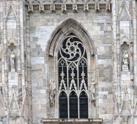 Old ancient window from Gothic period architecture on Duomo cathedral facadeの写真素材