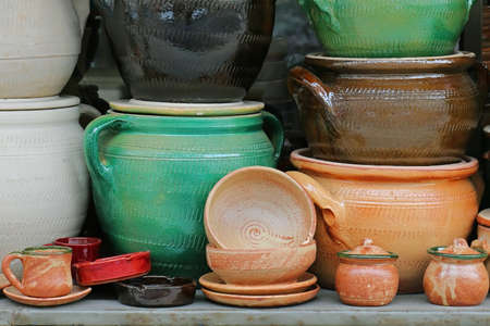 Retro handmade pottery on shelf sold on outdoor marketの写真素材