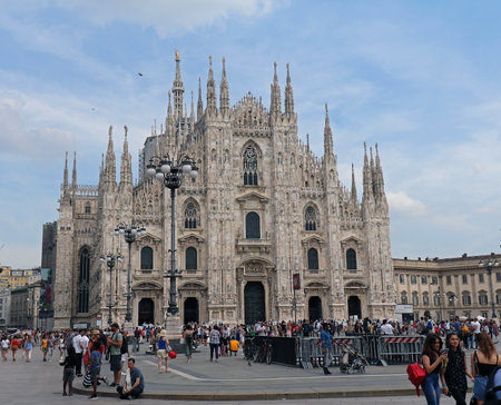 Milan, Italy - June 15, 2019: Large crowd of tourists standing in front of Duomo cathedral in Milan waiting to come into famous landmark and admiring ancient architectureのeditorial素材