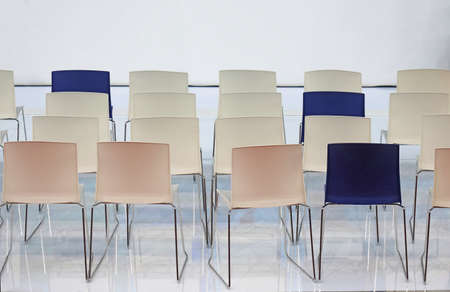 Empty chair seats in several rows inside interiorの写真素材
