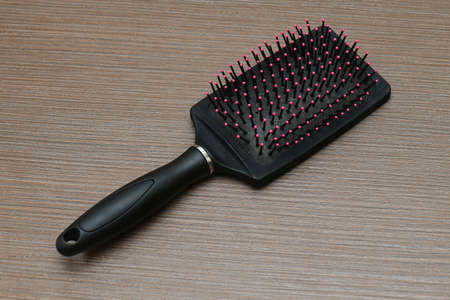 Plastic hair brush beauty accessory on brown wooden tableの写真素材
