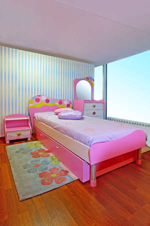 Small modern children girly pink bedroom interiorの写真素材