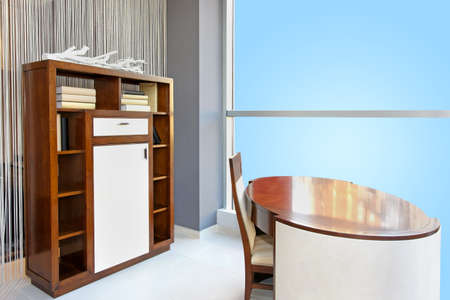 Modern interior with large window and wooden shelf furnitureの写真素材