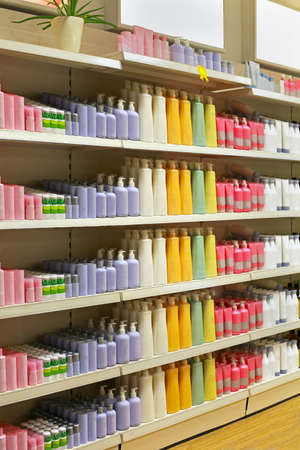Large shelf inside retail cosmetic store with colorful bottlesの写真素材