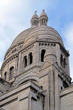Ancient church exterior with marble facade and blue sky in background in Parisの写真素材