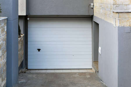 Garage closed entrance door exterior outside modern houseの写真素材