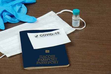 Coronavirus travel ID passport protection during international traveling to secure not spreading the disease with face mask gloves and covid-19 vaccineの写真素材