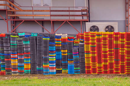 Large pile of colorful empty plastic crates in warehouse outdoorsの写真素材