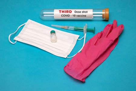 Third dose of Covid-19 vaccine as a booster shot in syringe ready to be administeredの写真素材