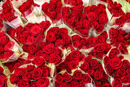 Bunch of red roses flowers sold on green marketの写真素材