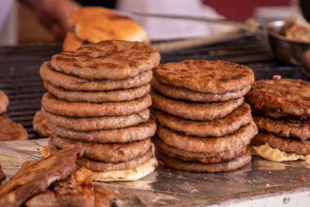 Stack of grilled hamburgers sold on local market fairの写真素材