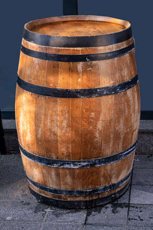 Old retro wooden barrel outside on street pavementの写真素材