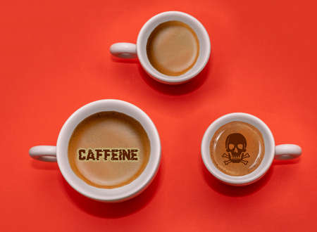 Espresso coffee inside ceramic cups with concept messages regarding the health of drinking caffeineの写真素材