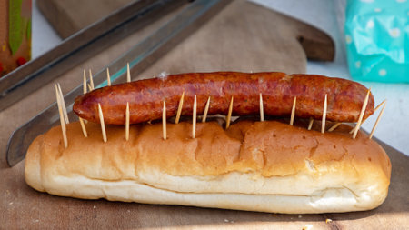 Grilled sausage on a bread ban sold on marketの写真素材