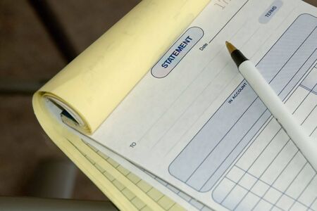 receipt book with penの写真素材