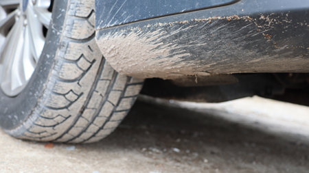 Car tire damage on the road. Close up of car wheel. mud, dirt in carの写真素材