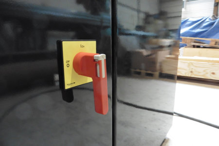 Close-up of a door handle with a red fire extinguisherの写真素材