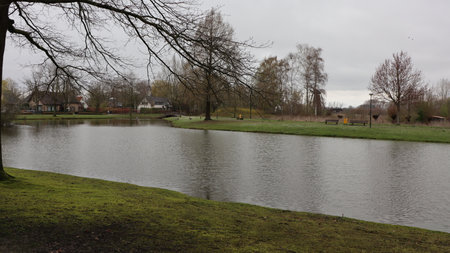 Lake in the village in late autumn. Landscape with lake and trees.の写真素材