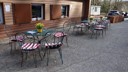 Outdoor cafe terrace with tables and chairs in the countryside.の写真素材