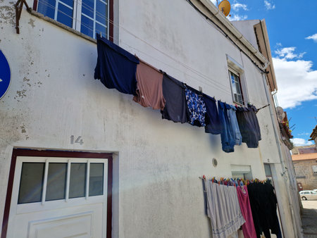 Laundry hanging on a clothesline in the old townの写真素材