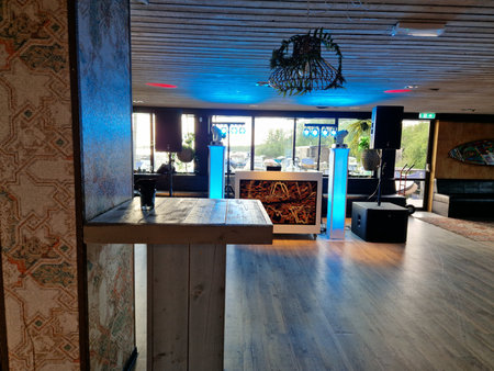 Interior of a restaurant with wooden tables, chairs and chairs.の写真素材