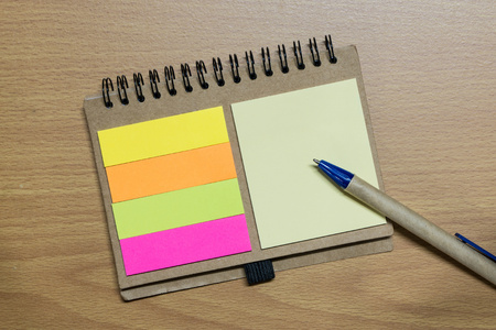 notebook and pen on wood floor