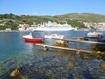 Adriatic idyllic scenery with view of huge cruise, ships, boats, mountains and clear turquoise water at the harbor of famous coastal town Dubrovnik, Mediterranean.の写真素材
