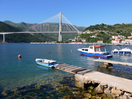 The Franjo Tudjman bridge and blue lagoon with boats and ships in harbor of Dubrovnik, Dalmatia, Croatia, Europeの写真素材