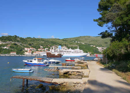 Adriatic idyllic scenery with view of huge cruise, ships, boats, mountains and clear turquoise water at the harbor of famous coastal town Dubrovnik, Mediterranean.の写真素材