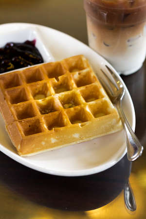 Lunch with a waffle and cold coffee in the cafe.