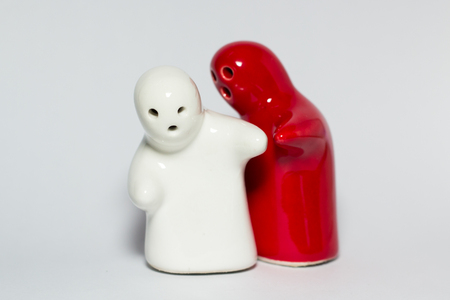 Two ceramic dolls on white background.の写真素材
