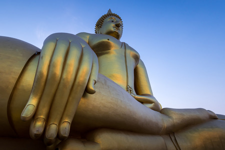 Golden Buddha statue in a temple, thailandの写真素材