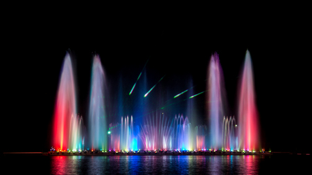 The colorful of fountain on the lake at night.の写真素材