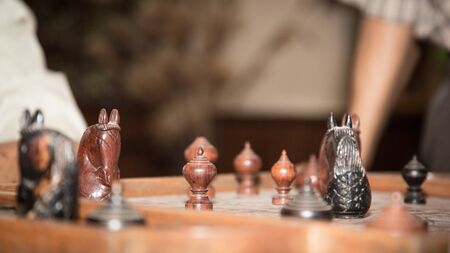 Two man playing thai chess on the wooden board.