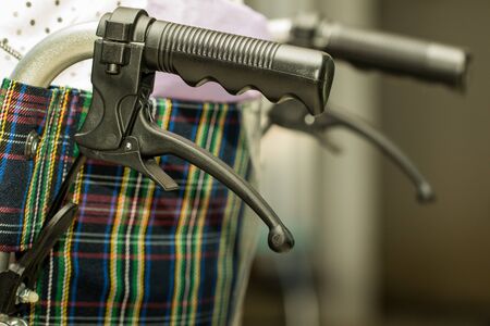 Close up of handle and brake of wheelchair.