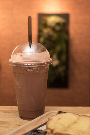 Cocoa smoothie with toast on a wooden table.の写真素材