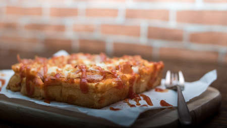 Pizza toast on a wooden table, Selective focus.の写真素材