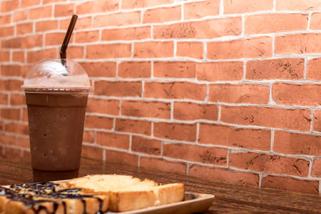 Cocoa smoothie with toast on a wooden table.の写真素材
