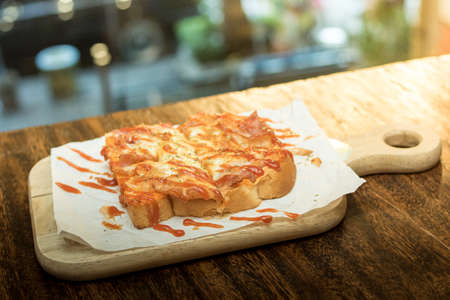 Pizza toast on a wooden table, Selective focus.の写真素材
