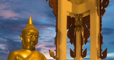 Golden Buddha statue in a temple, thailandの写真素材