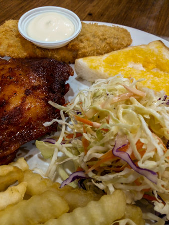 Grilled chicken with fried fish served with salad.の写真素材