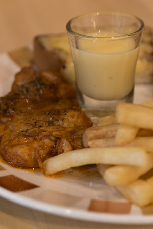 Grilled chicken with french fries served with salad.の写真素材