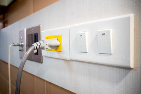 Light switch in the off position on white wall.の写真素材